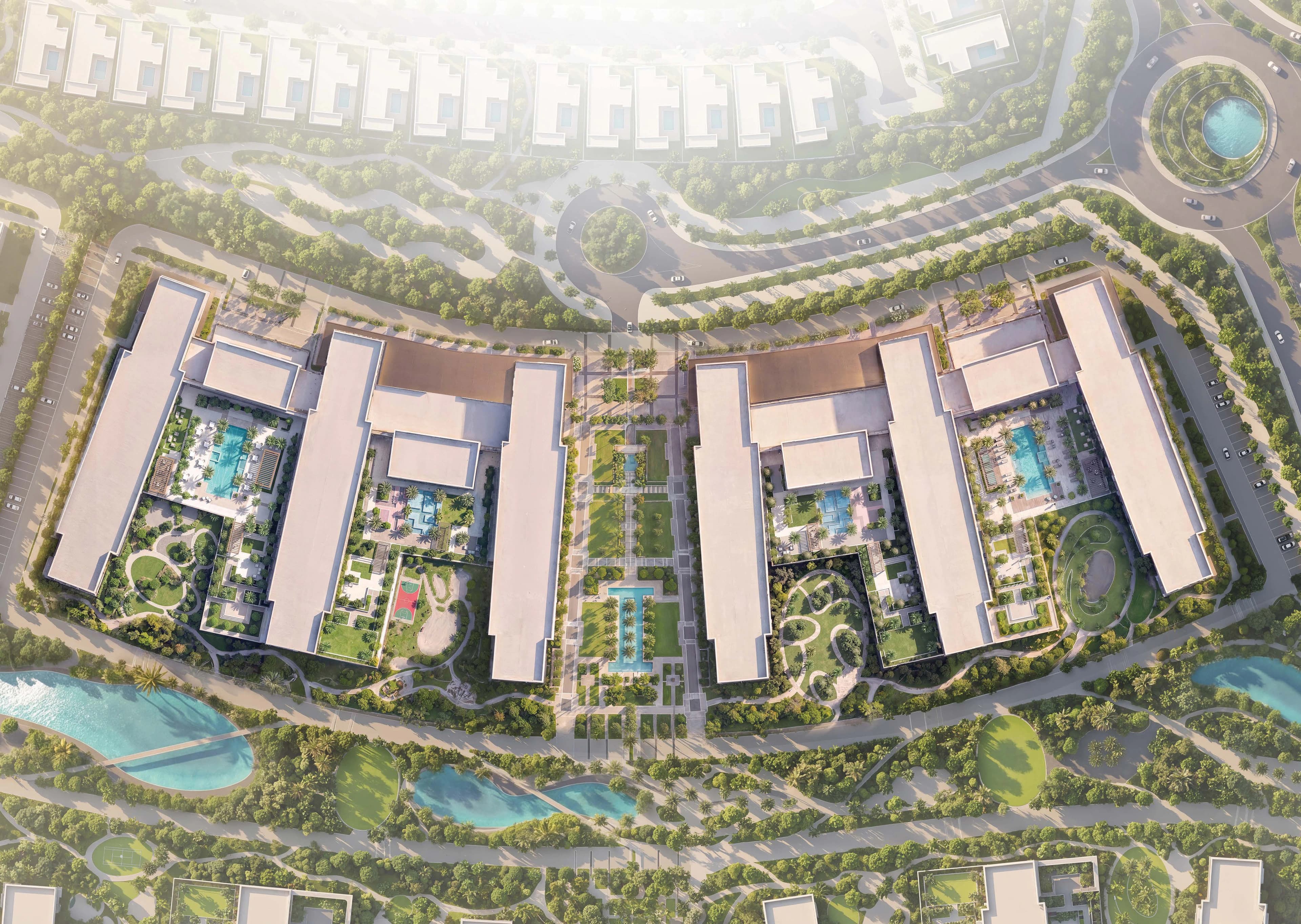 The Woods Abode — aerial view of apartment buildings, pools, and landscaped parkland
