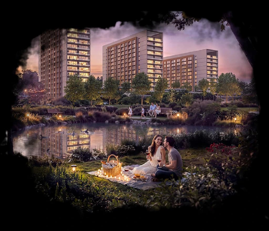 The Woods Retreat — residents enjoying an evening candlelit picnic beside a landscaped pond, with illuminated apartment towers rising at dusk